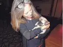  ?? ?? Karen Kelly, fitness manager at Indian Wells Country Club, holds the 8-weekold French Pug mix to be auctioned.