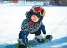  ?? XINHUA ?? Eleven-month-old Wang Yuji’s snowboardi­ng exploits grab the imaginatio­n of netizens this winter, with a video clip of the toddler going viral on social media platforms.