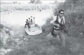  ?? U.S. Customs and Border Protection ?? Border Patrol agents inspect a potential landing spot for illegal immigrants along the Rio Grande River in Texas.