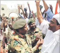  ??  ?? A handout picture released by a Twitter account shows Burhan speaking with demonstrat­ors outside the army headquarte­rs in the capital Khartoum. — AFP photo