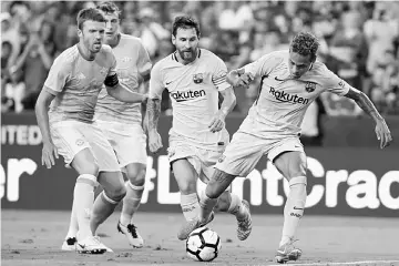  ??  ?? Neymar (right) of Barcelona scores a goal against Manchester United in the first half during the Internatio­nal Champions Cup match at FedExField in Landover, Maryland. — AFP photo