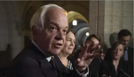  ?? ADRIAN WYLD/THE CANADIAN PRESS ?? John McCallum, minister of immigratio­n, refugees and citizenshi­p, talks with reporters during a break of the ad hoc committee on refugees on Friday.