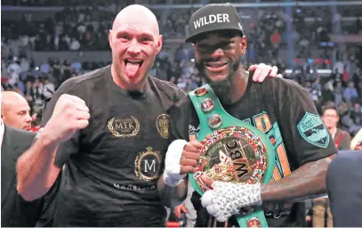  ?? Picture: Reuters ?? BIG MATES. Deontay Wilder (right) and Tyson Fury show each other some love after their WBC world heavy- weight title fight ended in a draw at the Staples Centre on Saturday night.