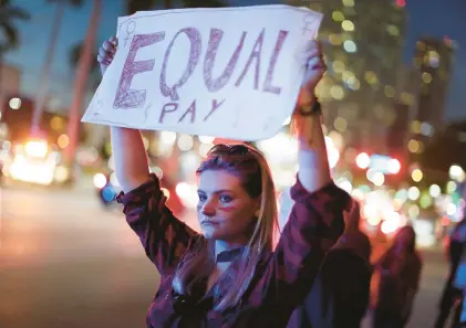  ?? JOE RAEDLE/GETTY ?? Equal Pay Day on March 14 marks the day each year when the average American woman’s salary finally catches up to the average salary a man earned during the previous year.