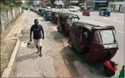  ?? ?? A Sri Lankan man walks past motorists in a queue up to buy fuel outside a gas station in Colombo, Sri Lanka, Thursday