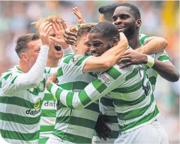  ??  ?? Olivier Ntcham is mobbed by his team-mates after scoring Celtic’s winner last Sunday