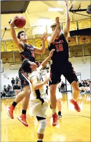  ?? Photo by Mike Eckels ?? Gravette’s Austin O’Brien (10) grabs a rebound as teammate Kelton Trembly (12) assists against Pottsville at the Tiger Dome in West Fork on Feb. 22.