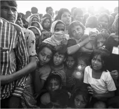  ??  ?? Photo shows Rohingya women and children gather to collect aid at the Kutupalong refugee camp in Cox’s Bazar. — AFP photo