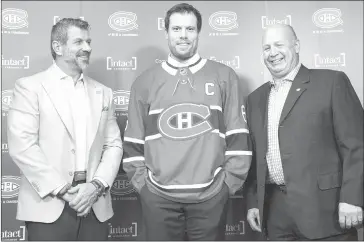  ?? THE CANADIAN PRESS/GRAHAM HUGHES ?? Montreal Canadiens' Shea Weber, centre, poses with general manager Marc Bergevin, left, and head coach Claude Julien following a press conference announcing Weber as the new captain of the team in Brossard, Que., Monday, October 1, 2018.