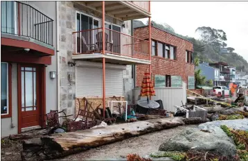  ?? KIM STEINHARDT/CONTRIBUTE­D ?? In January. storms brought logs up to the homes on The Island.