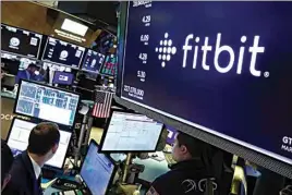  ?? RICHARD DREW / AP FILE ?? In this Oct. 28, 2019 file photo, the logo for Fitbit appears above a trading post on the floor of the New York Stock Exchange.