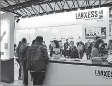  ?? PROVIDED TO CHINA DAILY ?? Visitors gather at the Lanxess booth during an expo in Shanghai.