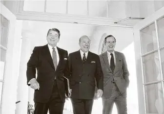  ?? Barry Thumma / Associated Press file photo ?? Secretary of State George P. Shultz, center, greets President Ronald Reagan and Vice President George Bush at the White House on Jan. 9, 1985, after two days of arms talks in Geneva.