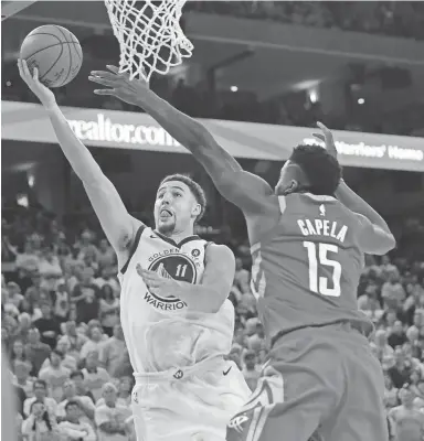  ?? MARCIO JOSE SANCHEZ/AP ?? Warriors guard Klay Thompson shoots against Rockets center Clint Capela during the second half of Game 6 on Saturday in Oakland, Calif. Thompson finished with 35 points.