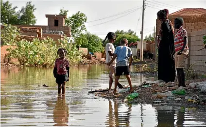  ?? AP ?? Used to an arid environmen­t, children explore a flooded area in the Salha neighbourh­ood in Khartoum’s Omdurman in Sudan.
