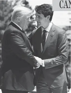  ?? LEON NEAL / GETTY IMAGES ?? Prime Minister Justin Trudeau and U.S. President Donald Trump greet each other on the first day of the G7 summit on Friday in Charlevoix, Que.