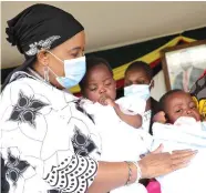  ?? — ?? First Lady Auxillia Mnangagwa holds the now grown twin girls she has been taking care of after they were born in a maize field and orphaned at birth in March last year. Pictures: John Manzongo