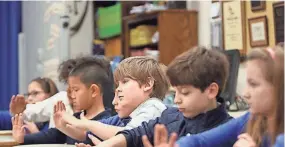  ?? CARROLL STAN ?? Students play instrument­s during music class at University of Memphis campus school. The university is beginning to move toward opening a middle school.