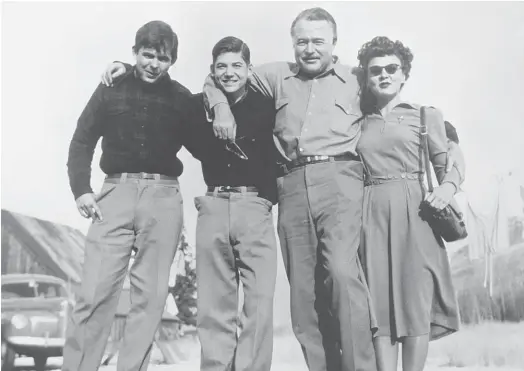  ??  ?? SCOOP: Ernest Hemingway, second right, with Lillian Ross, who largely invented the modern entertainm­ent profile with a piece on Hemingway.