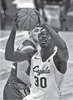  ?? JEFF ROBERSON/AP ?? Loyola-chicago’s Aher Uguak drives to the basket against Southern Illinois’ Anthony D’avanzo on March 5 in St. Louis.