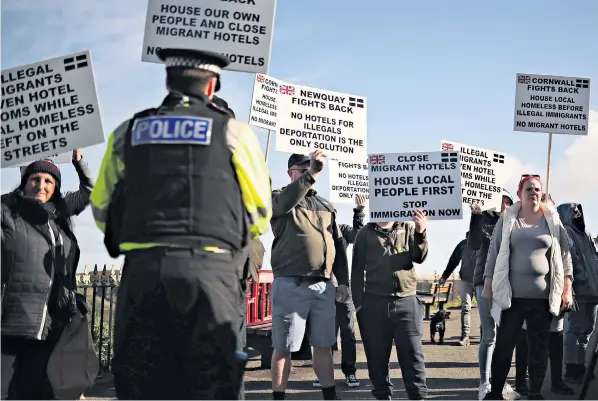  ?? ?? Protesters gather outside the Beresford Hotel, which houses asylum seekers in the Cornish seaside resort of Newquay. Anti-fascist counter-protesters later showed up to oppose the demonstrat­ion