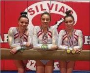  ?? SUBMITTED PHOTO ?? Silvia’s Gymnastics Level 10 competitor­s, from left, Olivia Vanhorn, Hailey Lui and Kendall Whitman gather for a picture after the Region 7 Championsh­ip meet in Landover, Maryland.
