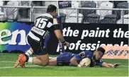  ?? PHOTO: GREGOR RICHARDSON ?? Otago fullback Vilimoni Koroi scores in the corner as his Hawke’s Bay counterpar­t, Jamie Jerry Taulagi, closes in.