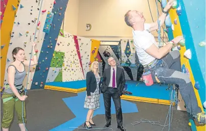  ??  ?? Top: Perth College and Goodlyburn Primary School children enjoy some balloon fun. Above: Education Secretary John Swinney and academy principal Margaret Munckton watch some climbers in action.