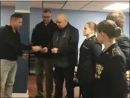  ?? KEVIN MARTIN — THE MORNING JOURNAL ?? Lorain Veterans Council Secretary Mike Kachure, left, presents a $2,000check to Colonel (Ret.) Tarn Warren and Sgt. First Class (Ret.) Chris Simon in support of Lorain High School’s Junior ROTC program on Feb. 21at American Legion Post #30, 1112 W. Erie Ave. in Lorain.