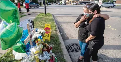  ?? TYLER LARIVIERE/SUN-TIMES ?? Evelina Rabadan (left), the aunt of Isaac Martinez, and Leticia Bello, the boy’s grandmothe­r, comfort each other at a vigil Tuesday for the 13-year-old, who was killed in a hit-and-run crash, police said.