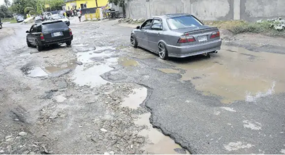  ?? (Photo: Karl Mclarty) ?? There is no way for motorists to avoid these potholes.