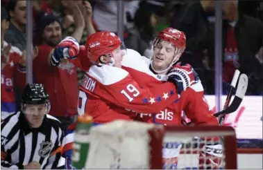  ?? NICK WASS - THE ASSOCIATED PRESS ?? Washington Capitals center Nicklas Backstrom (19), of Sweden, celebrates his goal with defenseman John Carlson, right,