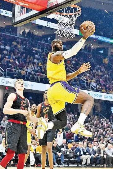  ?? AFP ?? LeBron James (centre) of the Los Angeles Lakers scores a basket during the first quarter against the Cleveland Cavaliers at Rocket Mortgage Fieldhouse on Monday.