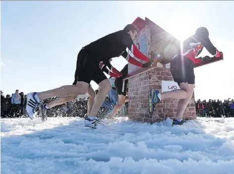  ?? PHOTOS: TROY FLEECE ?? Teams compete in the outhouse races during the reborn Waskimo Winter Festival held on Wascana Lake on Monday.