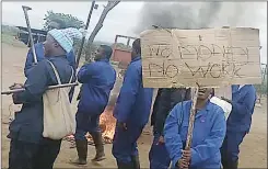  ?? ?? One of the workers hoisting a placard written ‘No Money, No Work’.