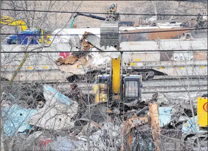  ?? Matt Freed The Associated Press ?? Workers clean up remaining tank cars last week in East Palestine, Ohio, following the Feb. 3 Norfolk Southern freight train derailment, which led to the release of unknown quantities of toxic chemicals.