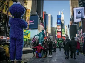  ?? BEBETO MATTHEWS - ASSOCIATED PRESS ?? In this Thursday photo, people snap pictures with familiar costumed characters, who solicit money to perform for the photos in Times Square in New York. Complaints about the sometimes aggressive behavior of the performers prompted the city in 2016 to passed a law relegating the Times Square characters to 8-by-50 foot “activity zones” where they might annoy fewer people.