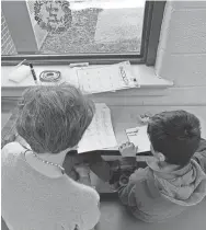  ?? COURTESY OF SHELBY COUNTY SCHOOLS ?? A volunteer works with a second grader to help him become a proficient reader. The volunteer is part of “Team Read.”