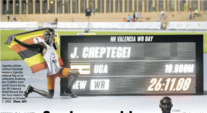  ?? (Photo: AFP) ?? Ugandan athlete Joshua Cheptegei waves a Ugandan national flag as he celebrates breaking the 10,000m track world record during the NN Valencia World Record Day at the Turia stadium in Valencia on October 7, 2020.