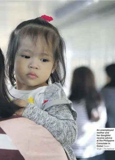  ?? Pawan Singh / The National ?? An unemployed mother and her daughter receive advice at the Philippine Consulate in Dubai