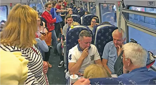  ??  ?? Standing room only: Overcrowdi­ng is common on ScotRail trains, while passengers face frequent delays and cancellati­ons