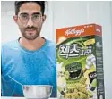  ?? JUWON PARK/AP ?? Journalist Raphael Rashid with a box of green onion-flavored Chex cereal in Seoul, South Korea.