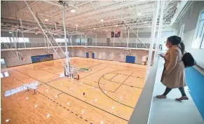  ??  ?? Sophia Fifner looks at the basketball courts from the walking track at the new Linden Community Center Tuesday.