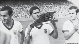  ??  ?? Gerd Müller with the Bundesliga "Torschütze­nkanone" or goal scorer's canon, which he won on seven occasions.