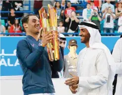  ?? —AFP ?? ABU DHABI: Spain’s Rafael Nadal receives his trophy from Sheikh Nahyan bin Zayed alNahyan, Chairman of Abu Dhabi Sports Council, after defeating Belgium’s David Goffin in the final match of the Mubadala World Tennis Championsh­ip 2016 in Abu Dhabi...