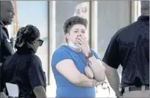  ?? PATRICK LANTRIP — DAILY MEMPHIAN VIA AP ?? Family members of victims wait with Memphis Police Department officers after a shooting Tuesday in Memphis.