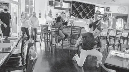  ?? JENNIFER LETT/SUN SENTINEL ?? Pizza chef Massimilia­no Stammera is pictured dancing, jumping and freestyle pizza-throwing Jan. 9 in his dining room to lively music as customers watch from their dining tables inside his restaurant GioiaEat in Hollywood.