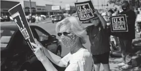  ?? [JOSHUA A. BICKEL/DISPATCH] ?? Rona Rosen of Bexley takes part in a Save the Post Office rally in Whitehall last month.