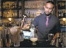  ??  ?? Bartender Sid Vergara pours Paradise Square cocktail at the new Five Points cocktail bar in downtown San Jose.