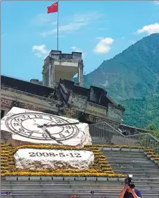  ??  ?? Left: The structure of a clock at the Wenchuan Earthquake Memorial Museum is inscribed with the date and time when Sichuan was hit by a massive earthquake. Right: Taoping Qiang village, home of the Qiang people, is known for its ancient stone...